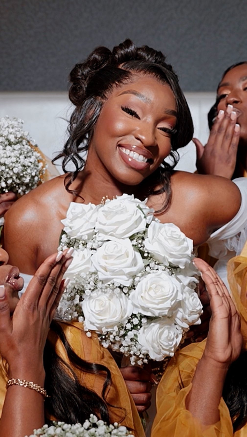 Bride holding a bouquet of white roses