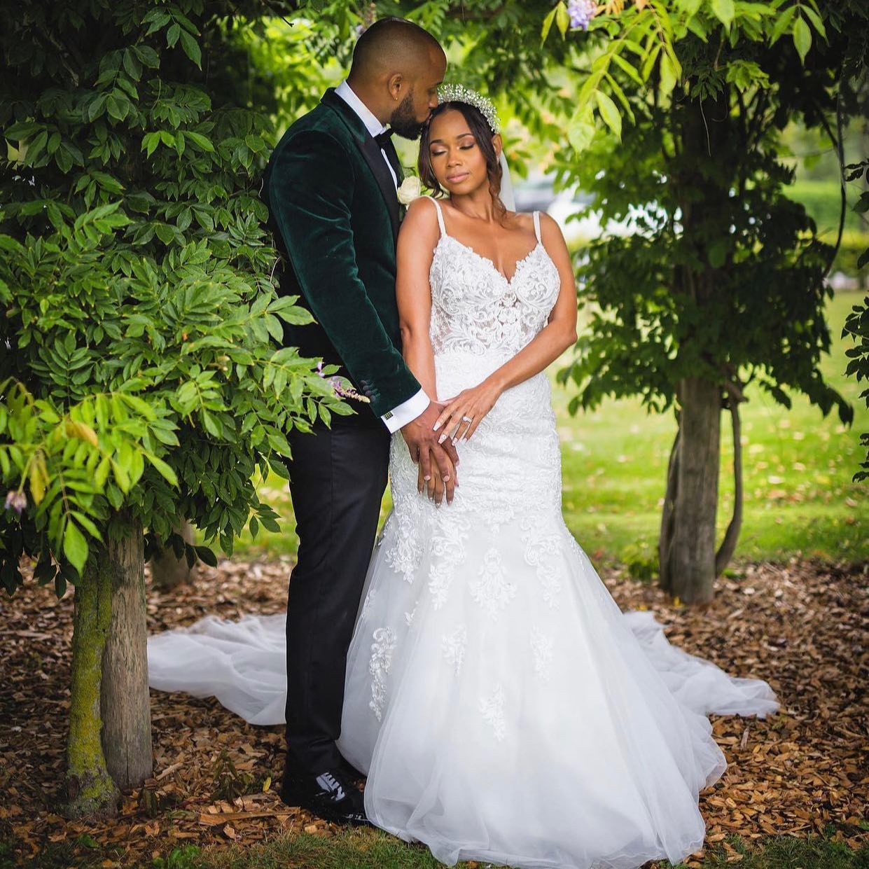L&L couple portrait under wisteria after their wedding ceremony